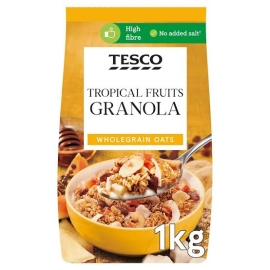 Tesco Tropical Fruits Granola 1kg pack of crunchy granola made with whole grain oats, mixed tropical fruits, and nuts, rich in fiber and nutrients, ideal for a healthy breakfast or snack with milk or yogurt.