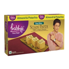 Haldiram's Prabhuji Ghee Soan Papdi 200g box featuring traditional Indian flaky sweet made with rich ghee, cardamom, pistachio, and almond toppings.