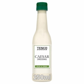 Tesco Caesar Dressing 250ml bottle featuring creamy Caesar salad dressing, ideal for adding rich flavour to salads, wraps, and meals.